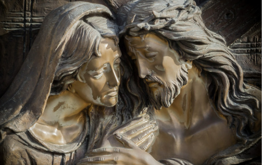 Mary and Jesus embrace near the cross