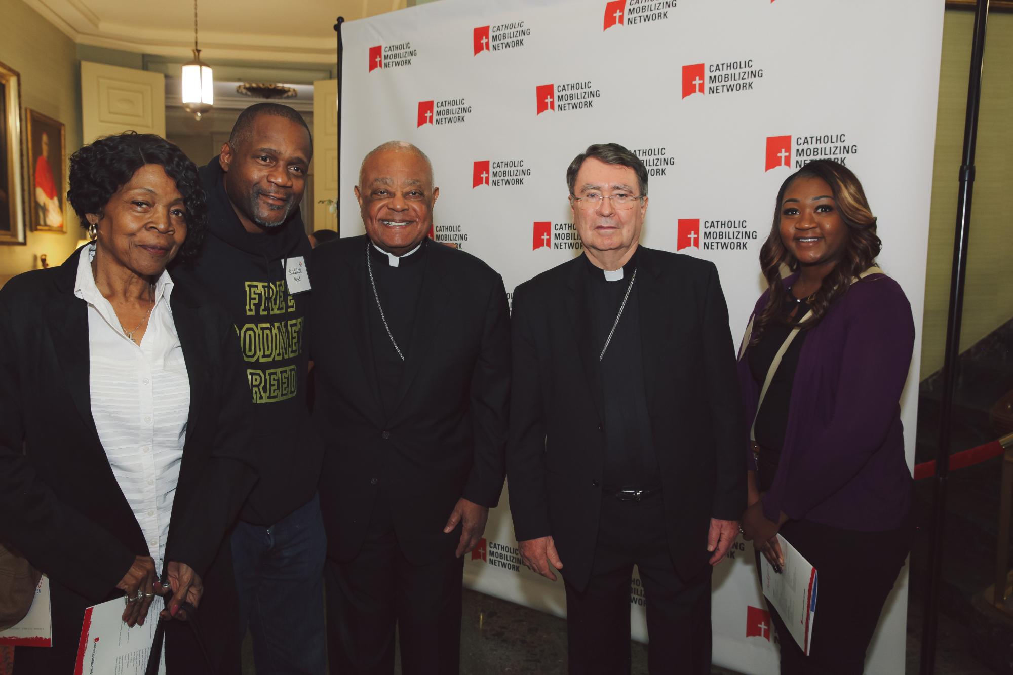 Guests stand with Cardinal Gregory and Abp. Pierre