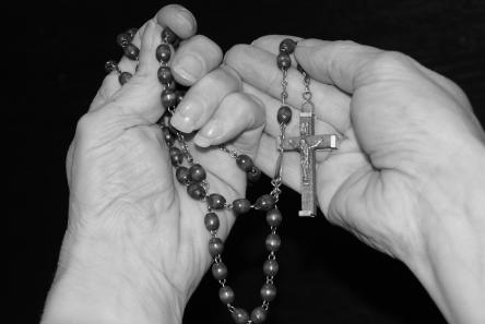 Hands holding rosary
