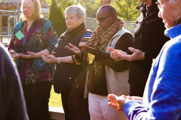 CMN circle training participants praying in a circle