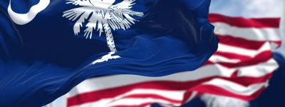 South Carolina flag waves next to American flag