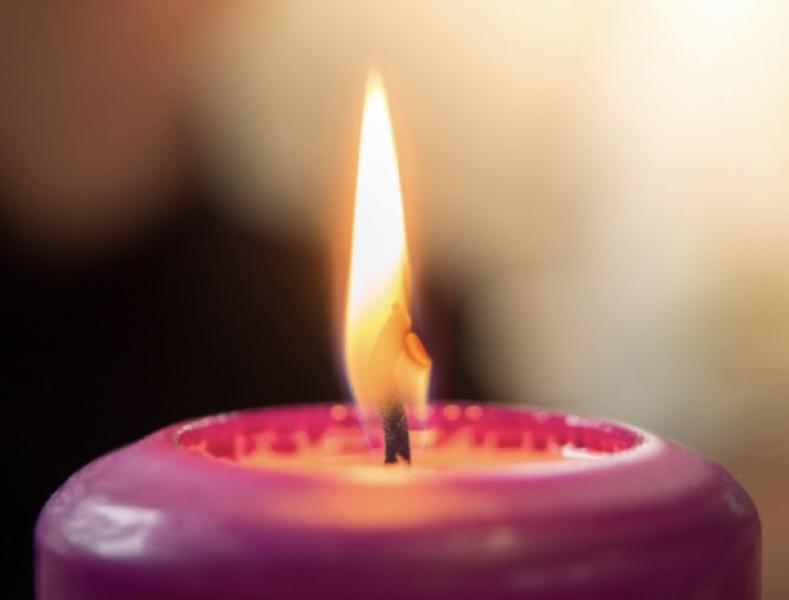 close up of a pink candle with tall flame