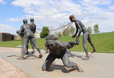 sculpture of people forced into slavery, connected by chains