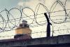 barbed wire around prison watch tower