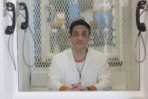 Ivan Cantu sits in a visitors cell in prison